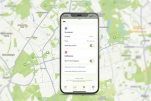 iPhone with Find My in front of Maps
