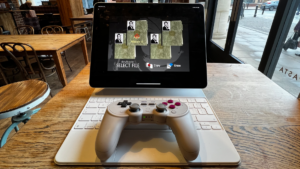 8BitDo controller playing GoldenEye on iPad Pro in coffee place