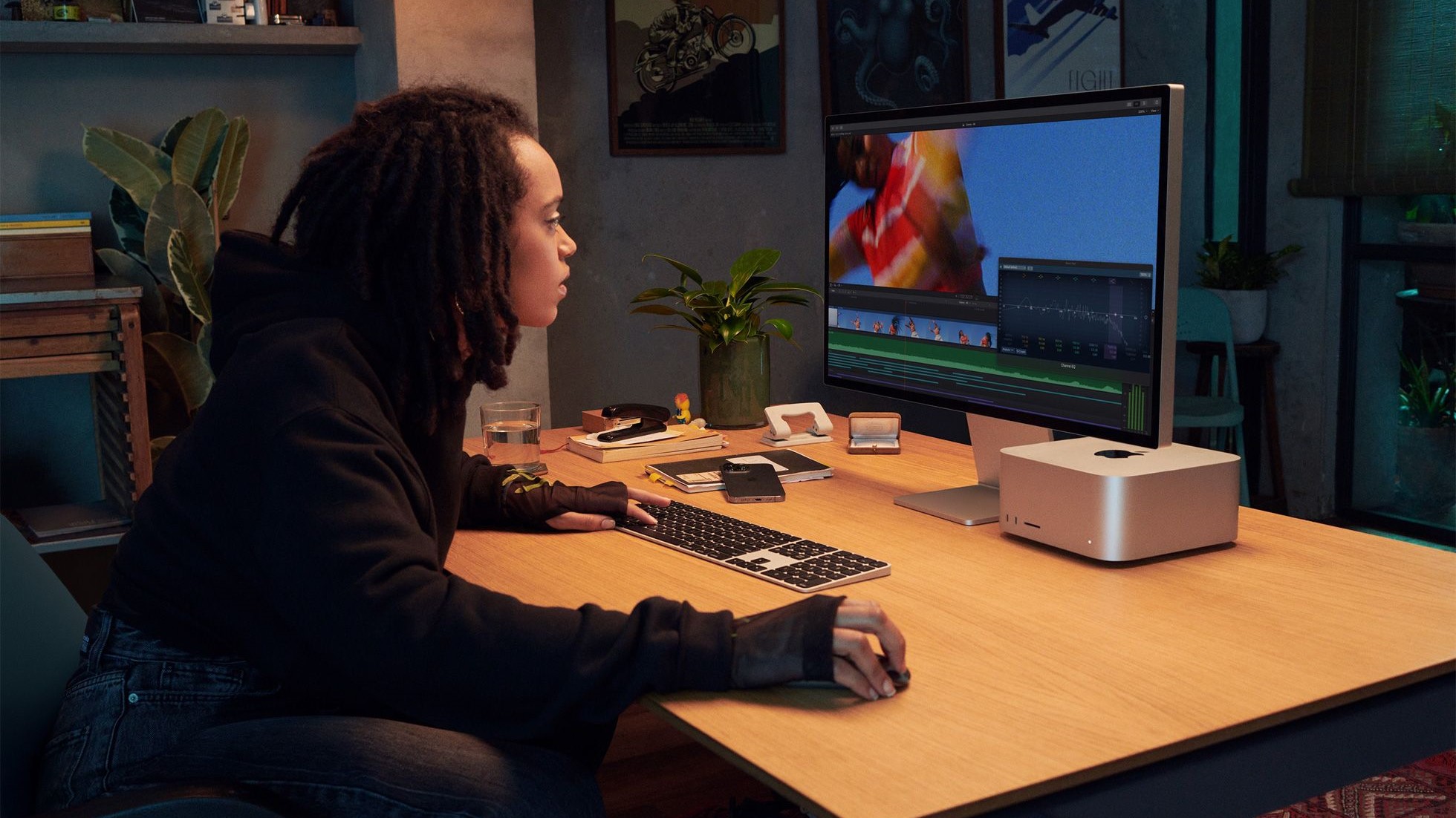 Uma senhora usando um estúdio Mac em uma mesa