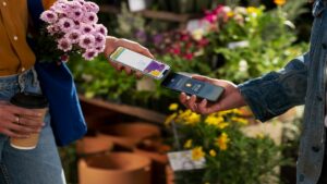 A picture of Apple pay being used between two iPhones