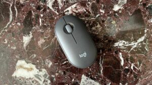 The Logitech Pebble Mouse 2 M350S seen from above on a marble worktop.