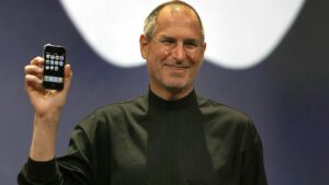 Steve Jobs holding the original iPhone in 2007