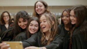 This is an image of a group of young women taking a group selfie in the documentary film “Girls State